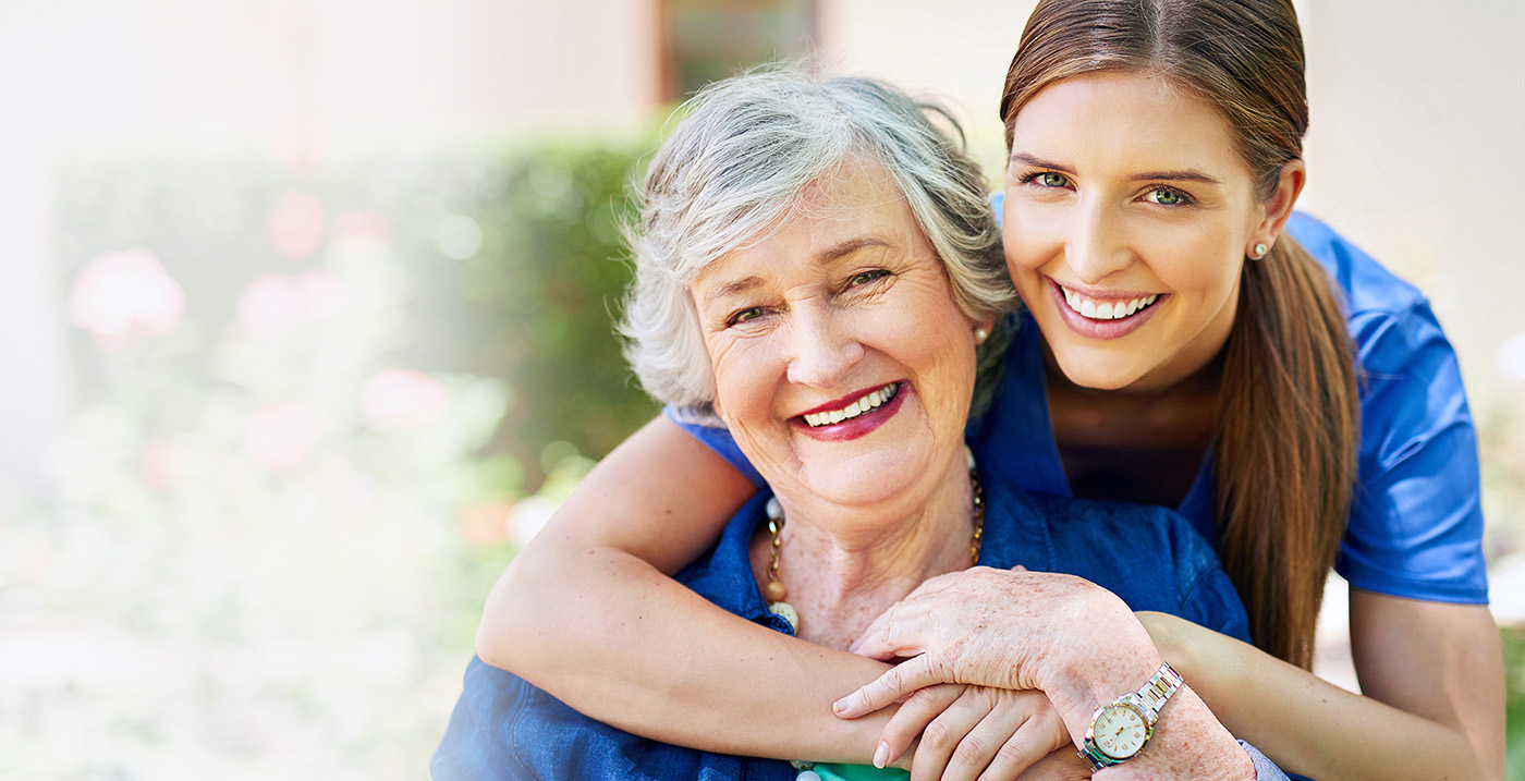 a resident and a caregiver outside